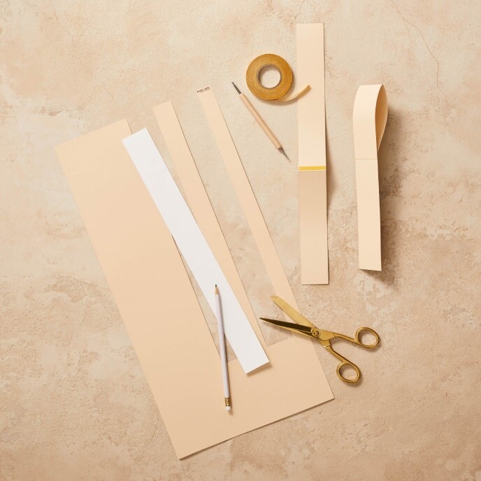 Step 3: An image showing cardboard paper displaying the template for Easter basket handles, pre-folded at the markings.