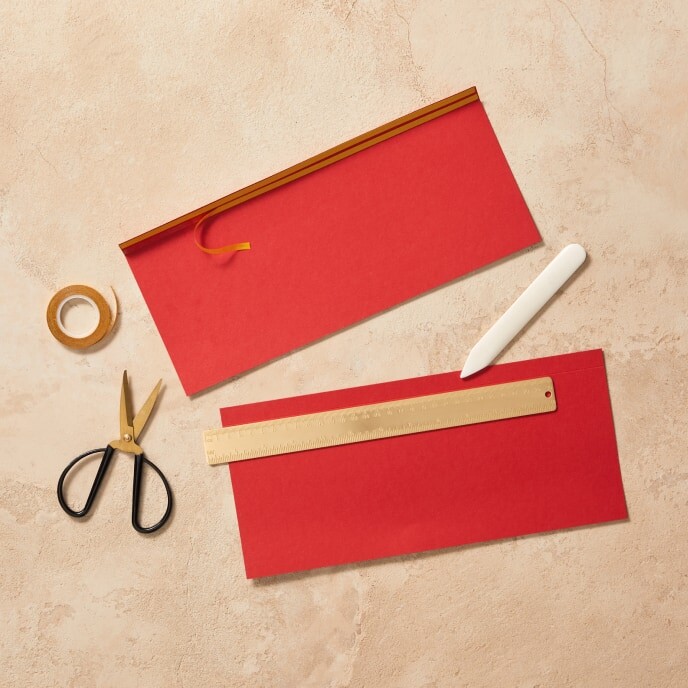 Step 2: An image displaying two rectangular pieces of red and pink cardboard folded along their long sides.